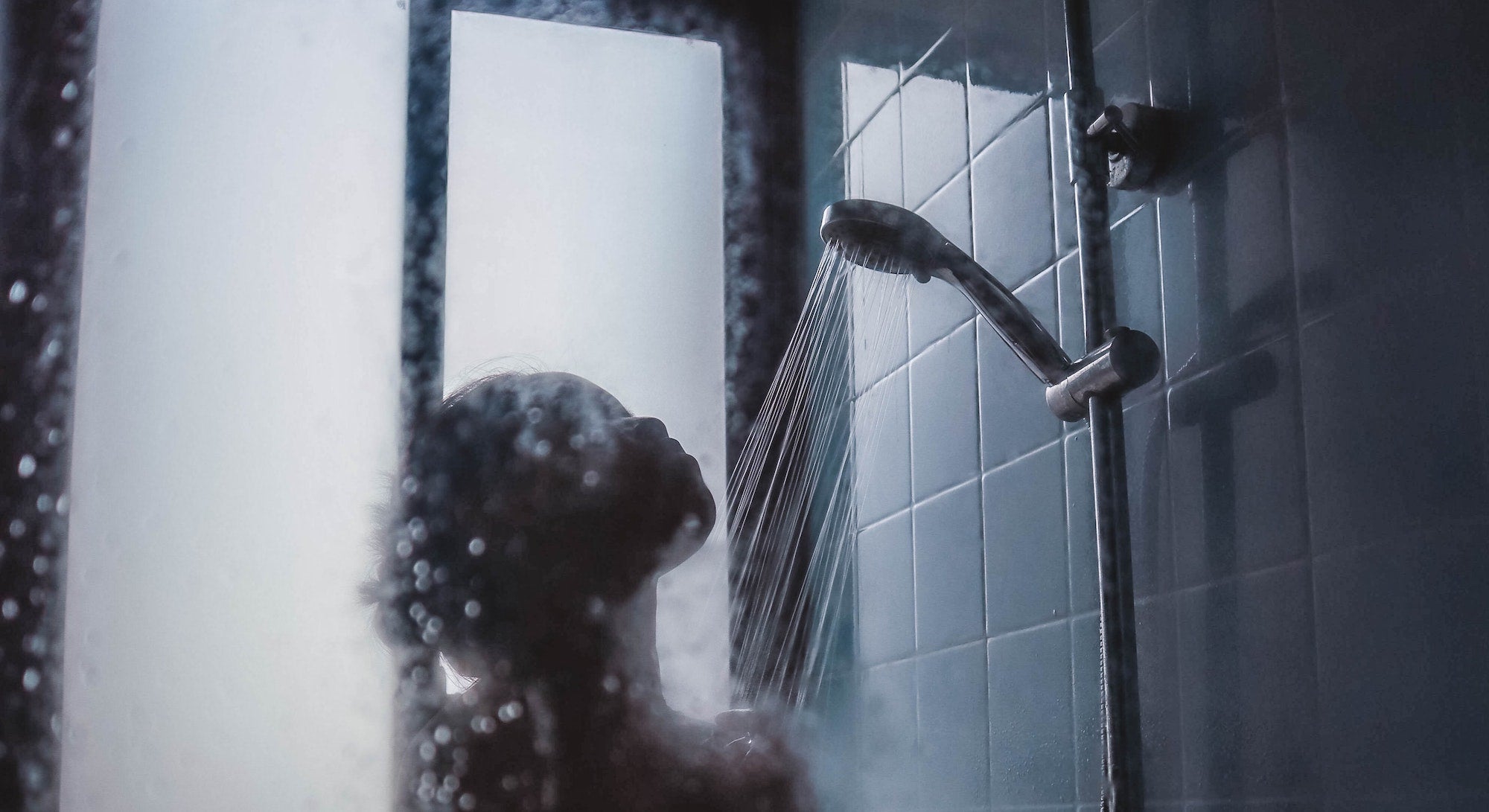 woman under showerhead