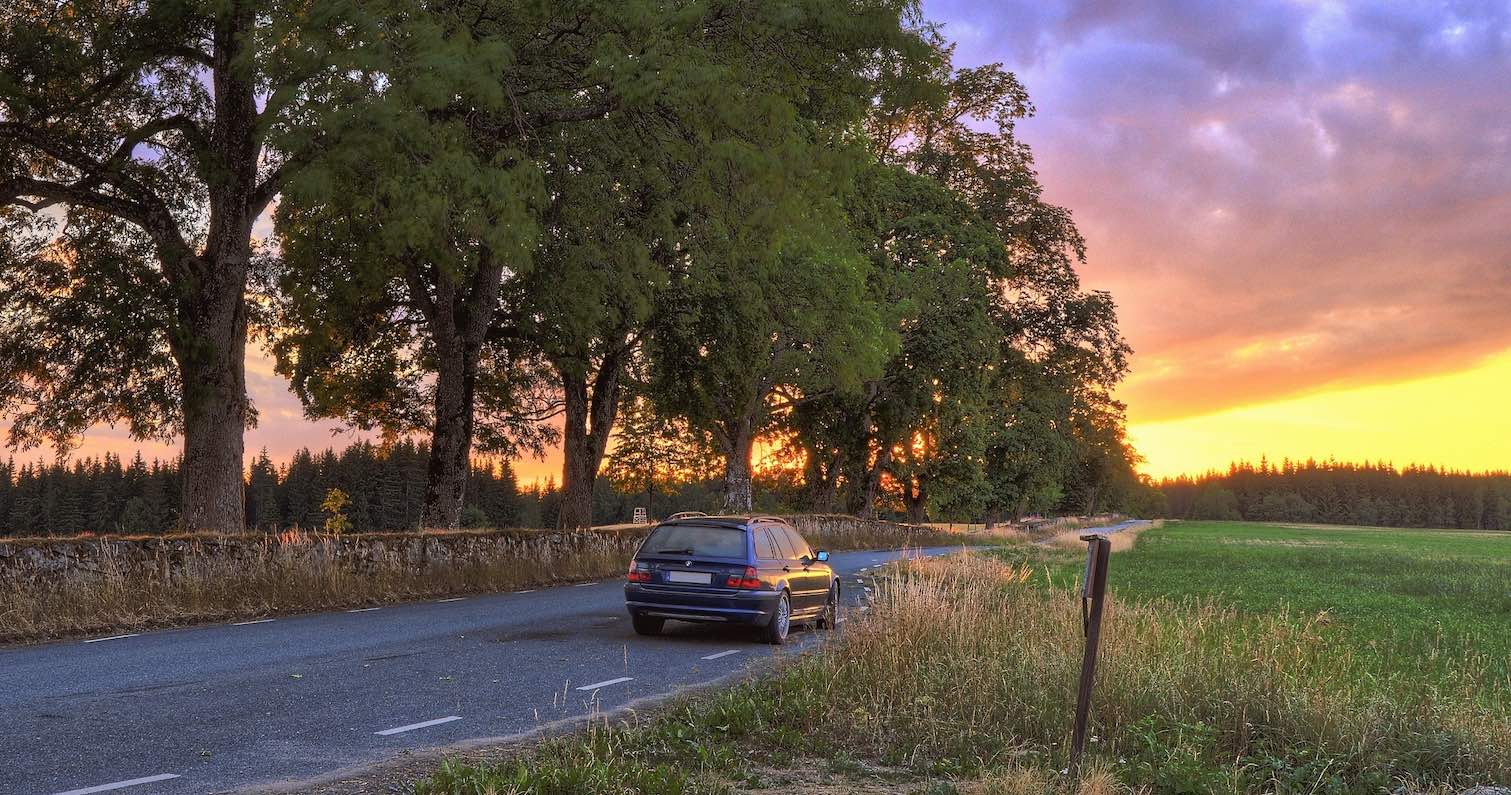 car driving on road during sunset