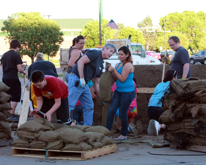 people loading sand bags