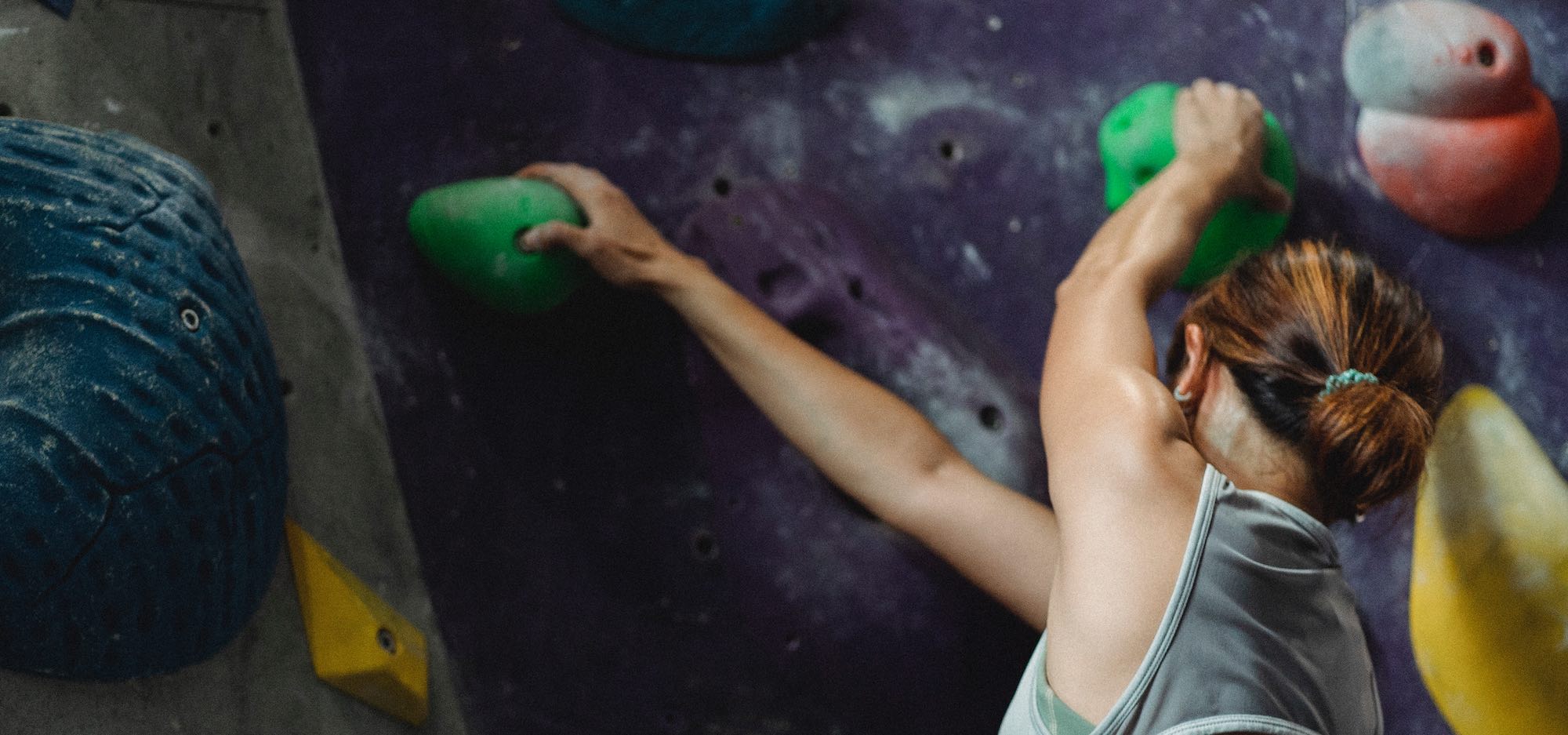 woman climbing indoor rock