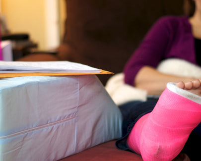 woman elevating her foot in a cast