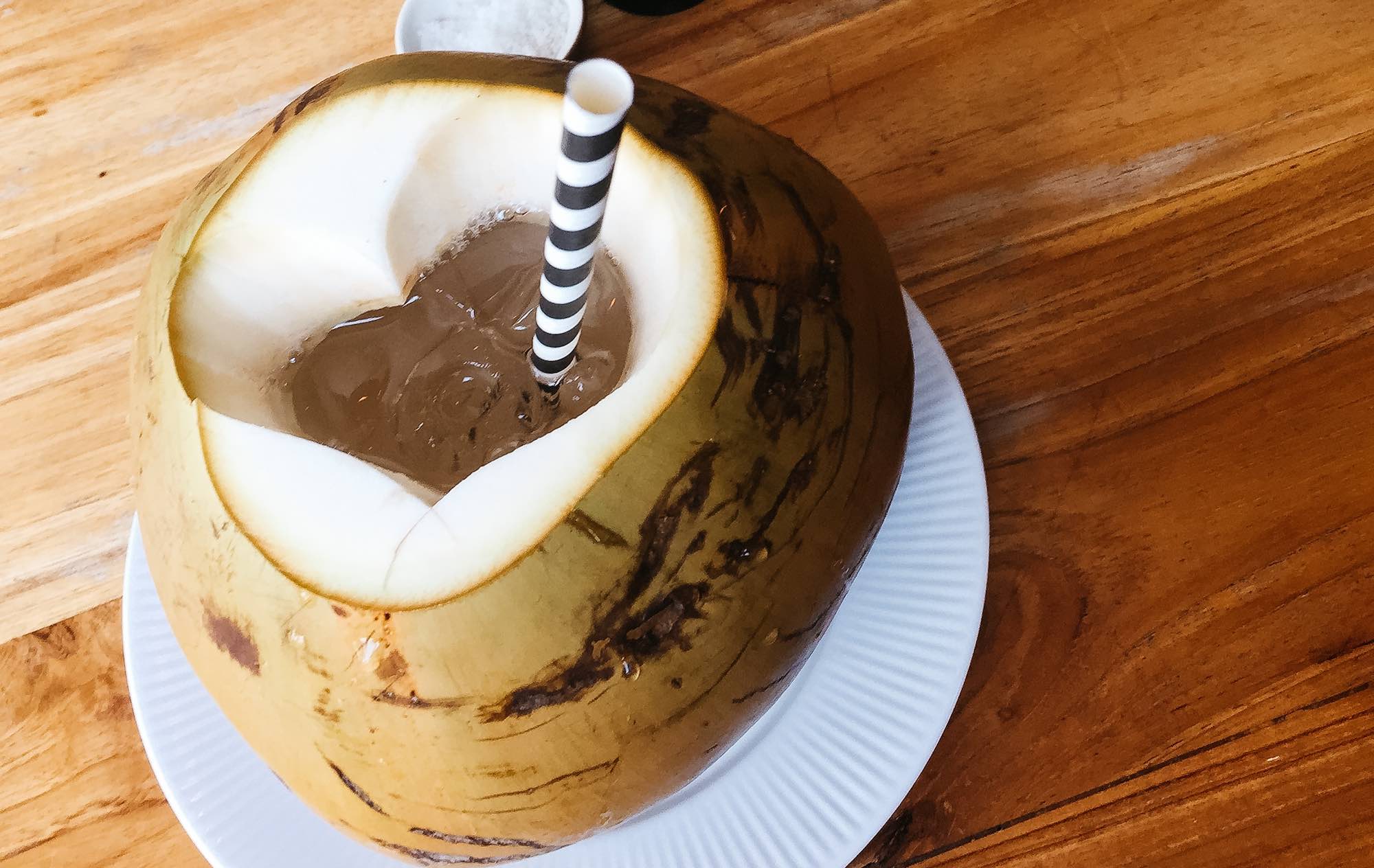 raw coconut with water and straw