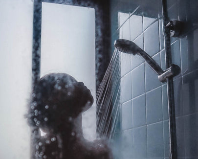 woman under showerhead