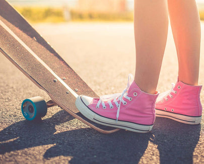 pink converse on a skateboard