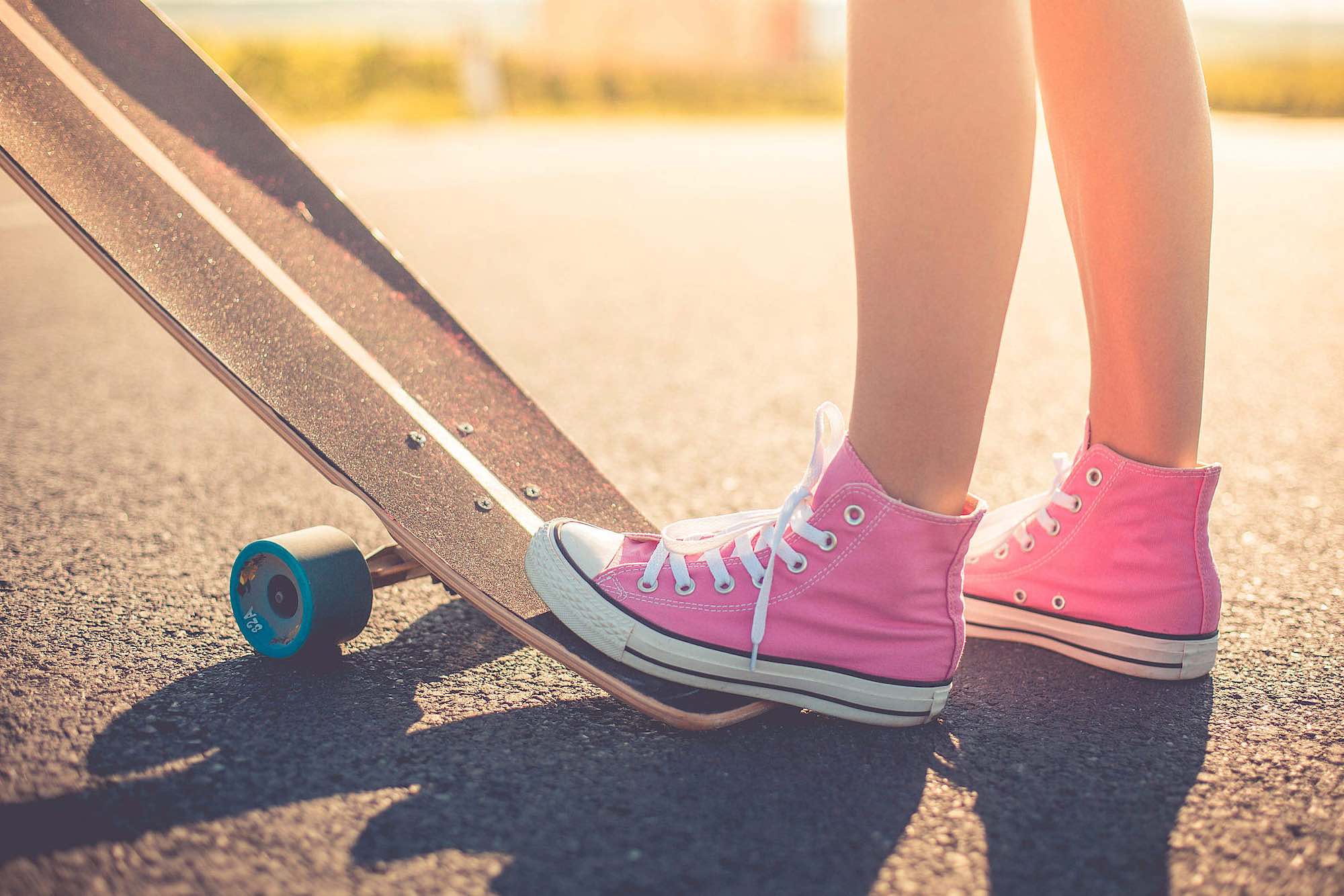 pink converse on a skateboard