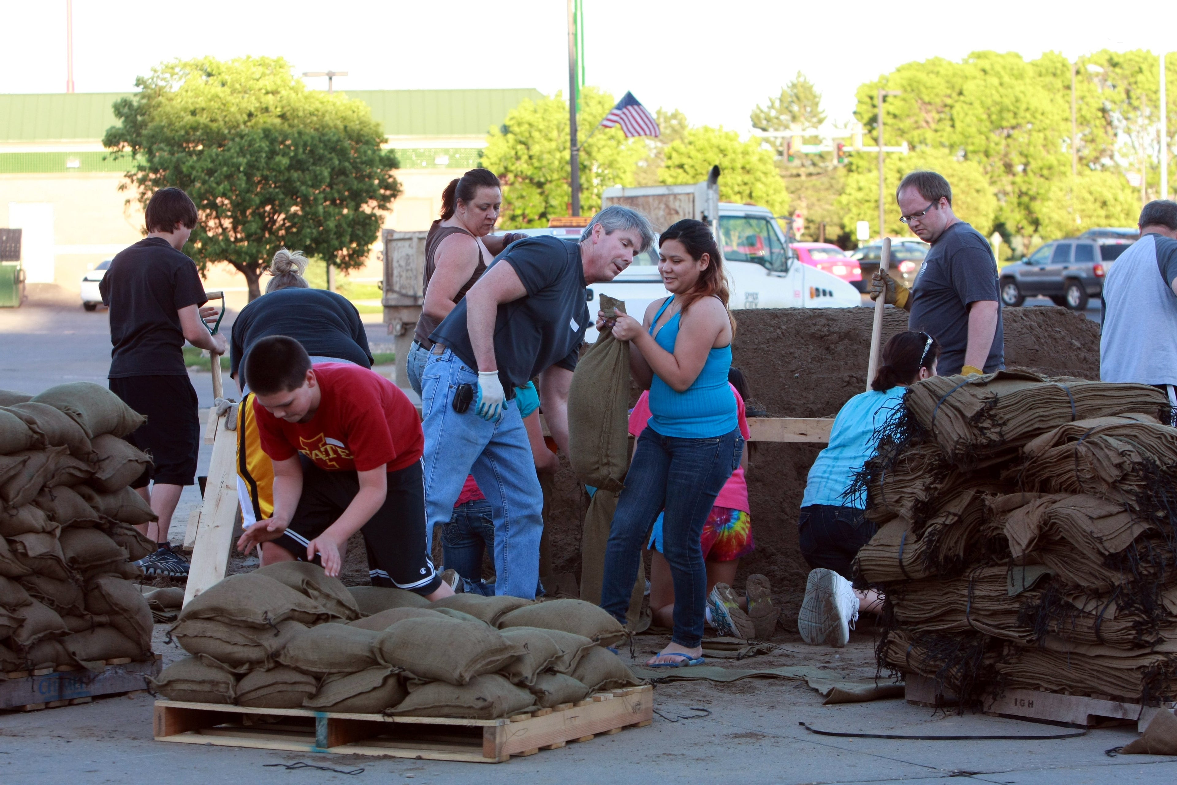 people loading sand bags