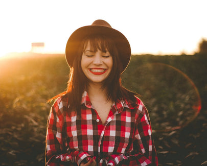 golden hour photography of woman in red and white checkered dress shirt