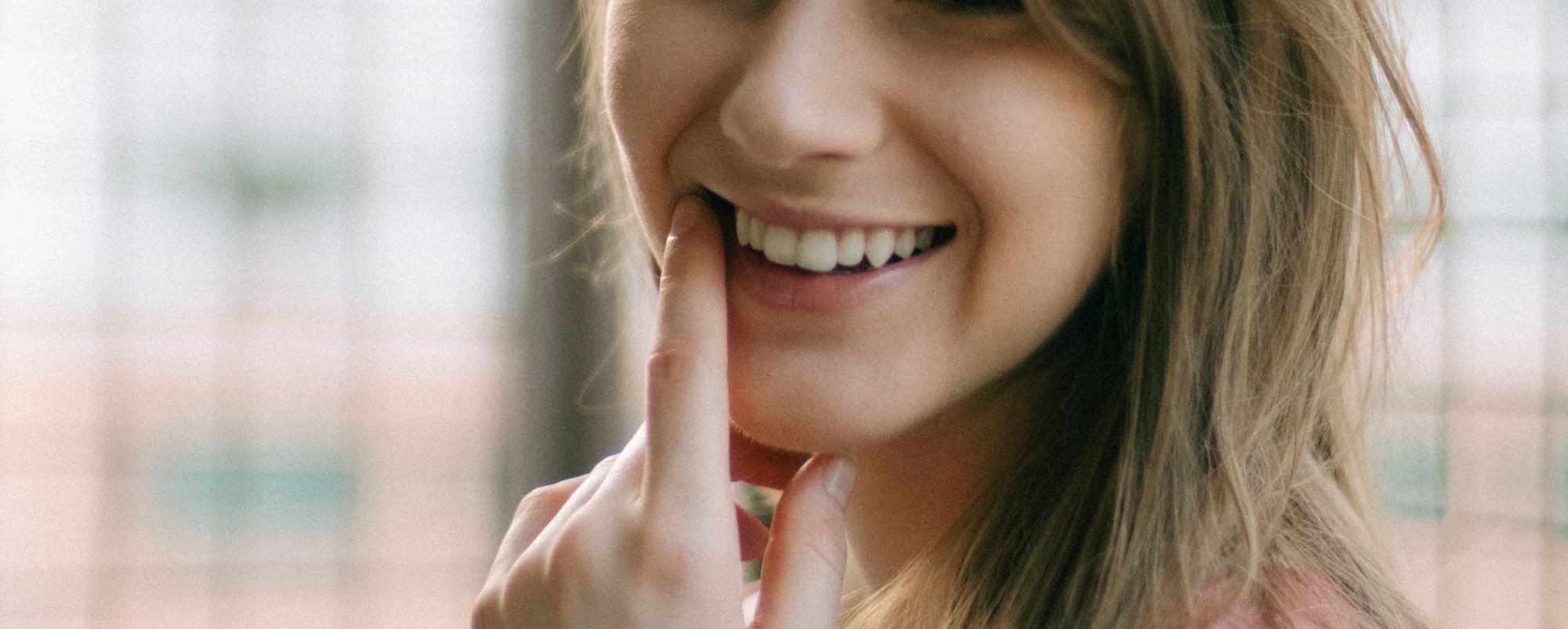 woman in pink tank top smiling