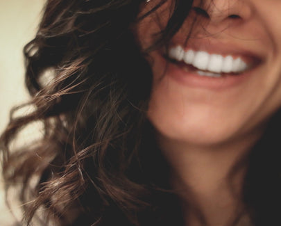 long black haired woman smiling close-up photography
