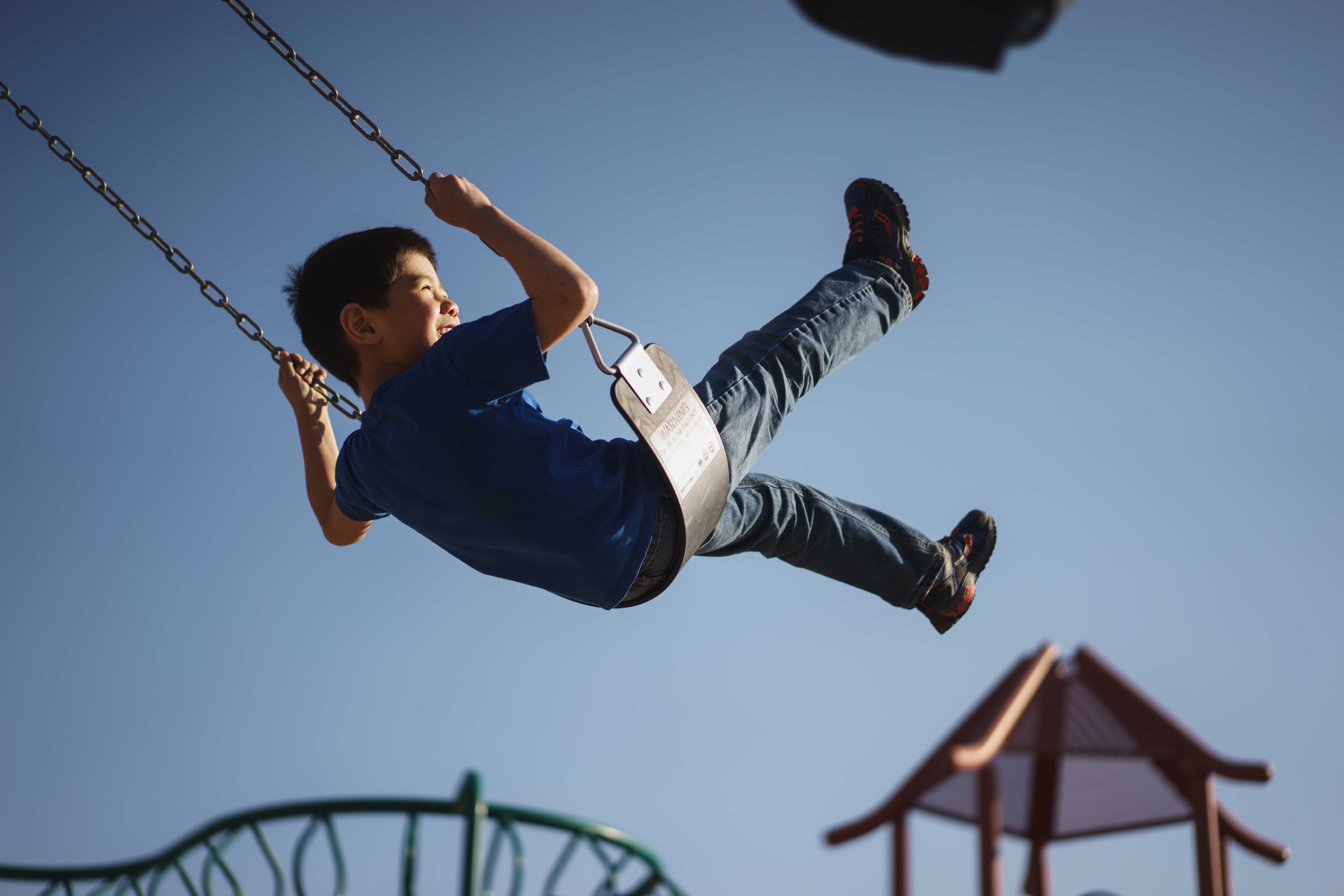 young boy swinging