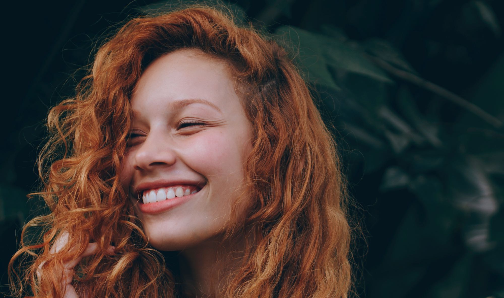 woman with red hair smiling