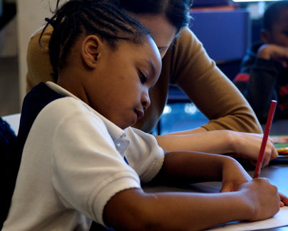 kid in school writing